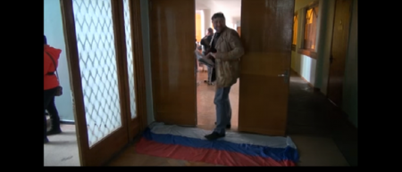 В Рубежном боевики заставили депутатов заходить в зал заседания, наступая на российский флаг